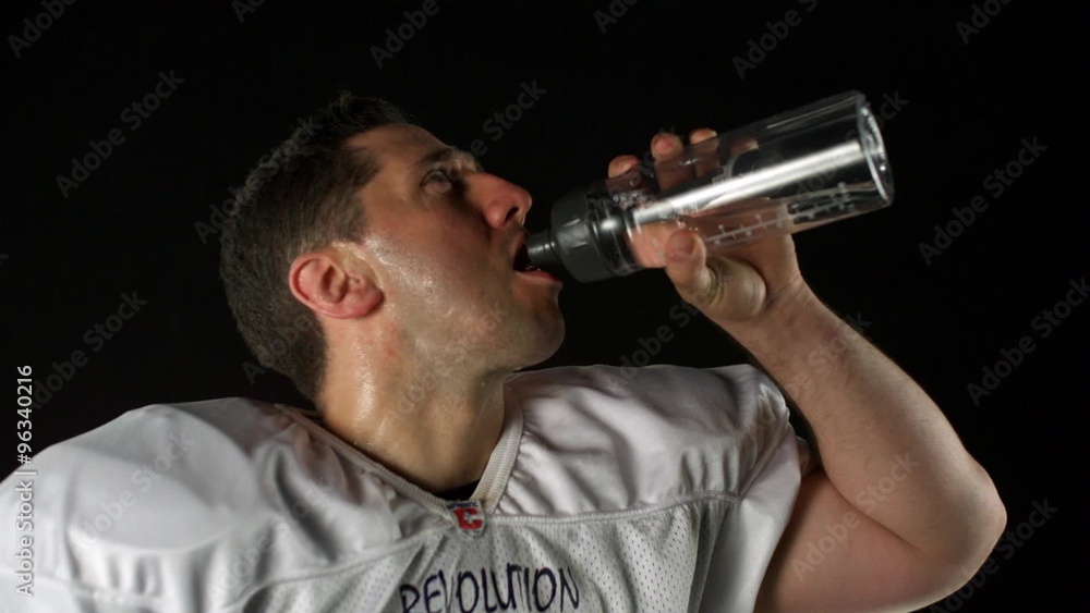 American football player drinking water out of bottle shooting with high speed camera, phantom flex. American football player drinking water out of bottle shooting with high speed camera, phantom flex.