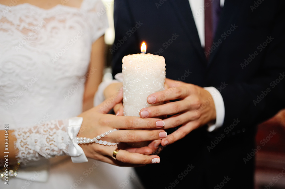 Wedding candles in the hands of the newlyweds Wedding candles in the hands of the newlyweds