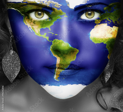 Map of the world on face of girl with green eyes