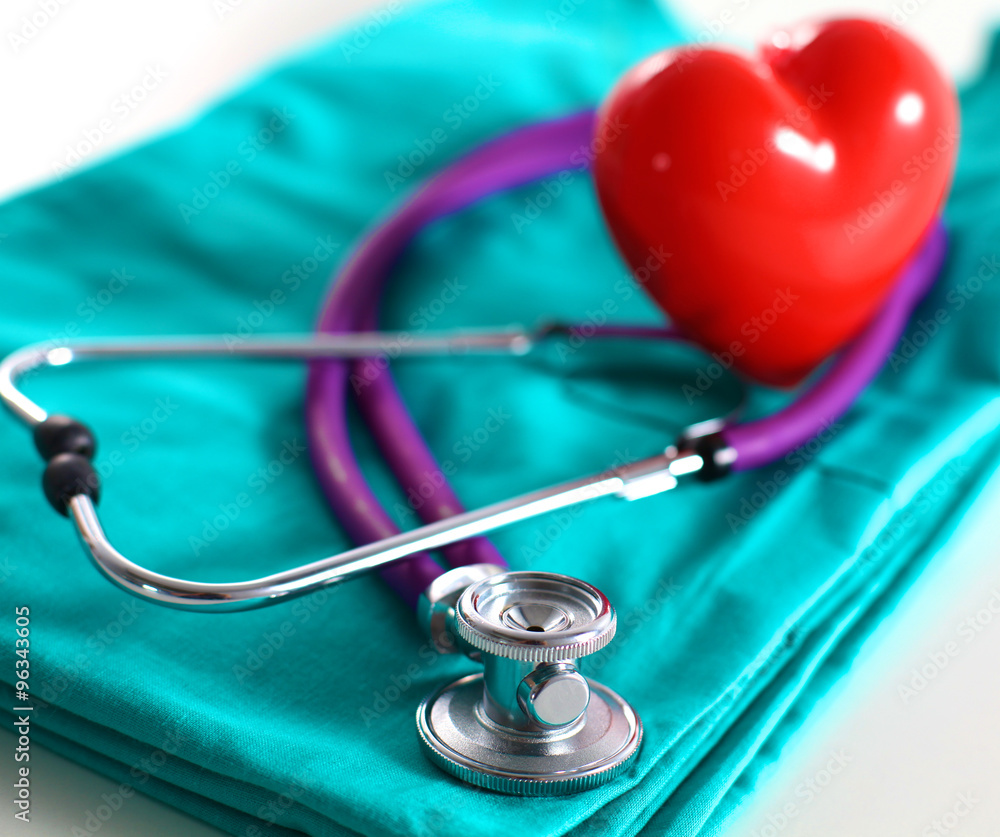 A stethoscope shaping a heart and a clipboard on a medical uniform, closeup A stethoscope shaping a heart and a clipboard on a medical uniform, closeup