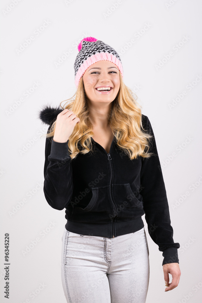Teenage blonde girl in winter outfit laughing Teenage blonde girl in winter outfit laughing