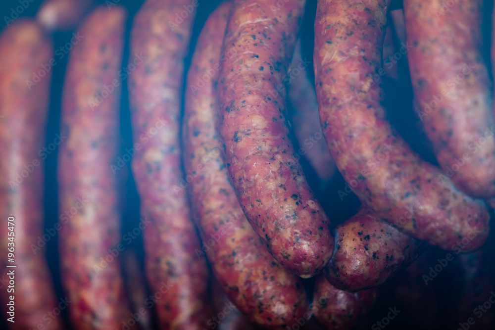 Fototapeta premium Traditional food. Smoked sausuages in smokehouse.