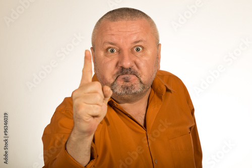 An angry man with beard pointing finger at you
