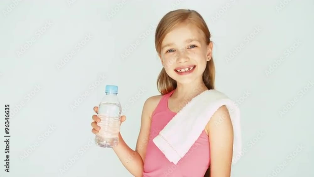 Portrait sportswoman girl child showing bottle of water at camera Portrait sportswoman girl child showing bottle of water at camera