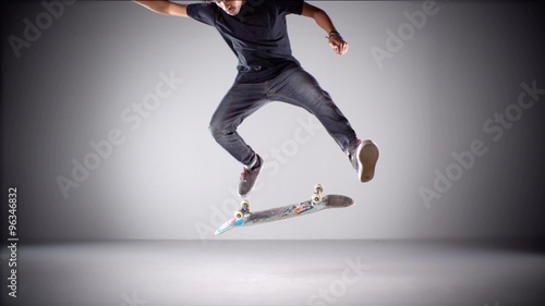 Skater rolling into kickflip trick shooting with high speed camera, phantom flex. photo