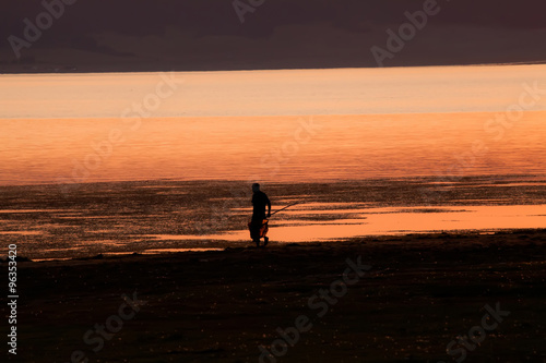man silhouette near lake
