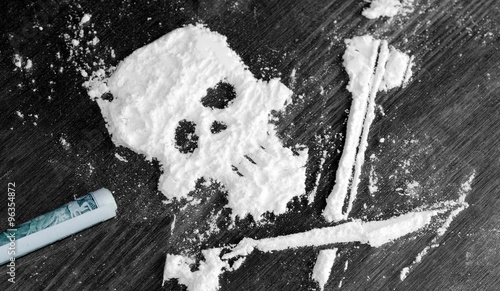 Drug powder cocaine in the silhouette of the skull photo