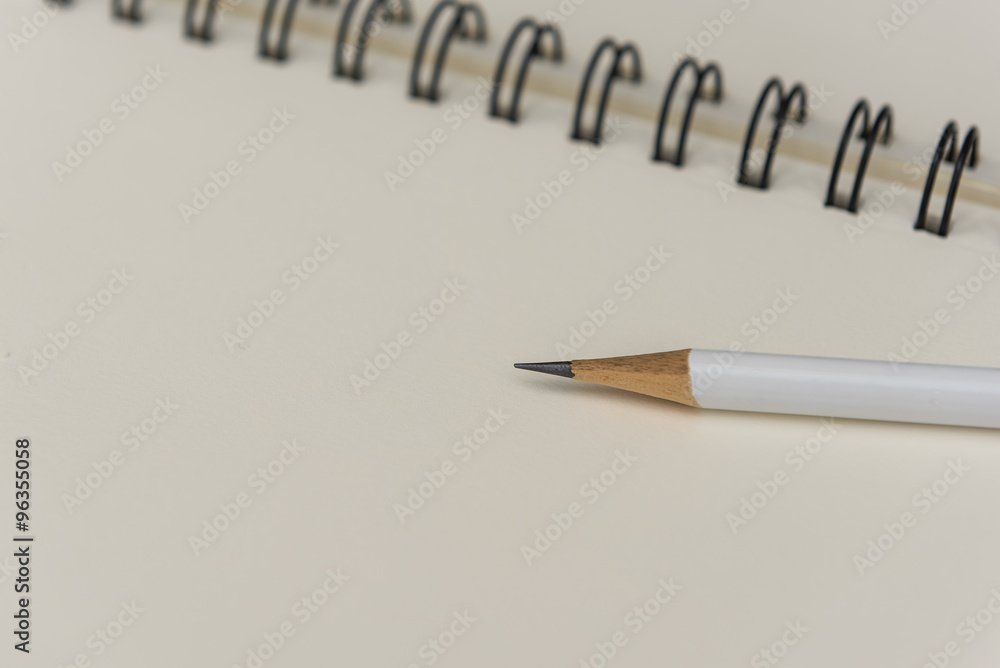 white pencil with blank notebook white pencil with blank notebook