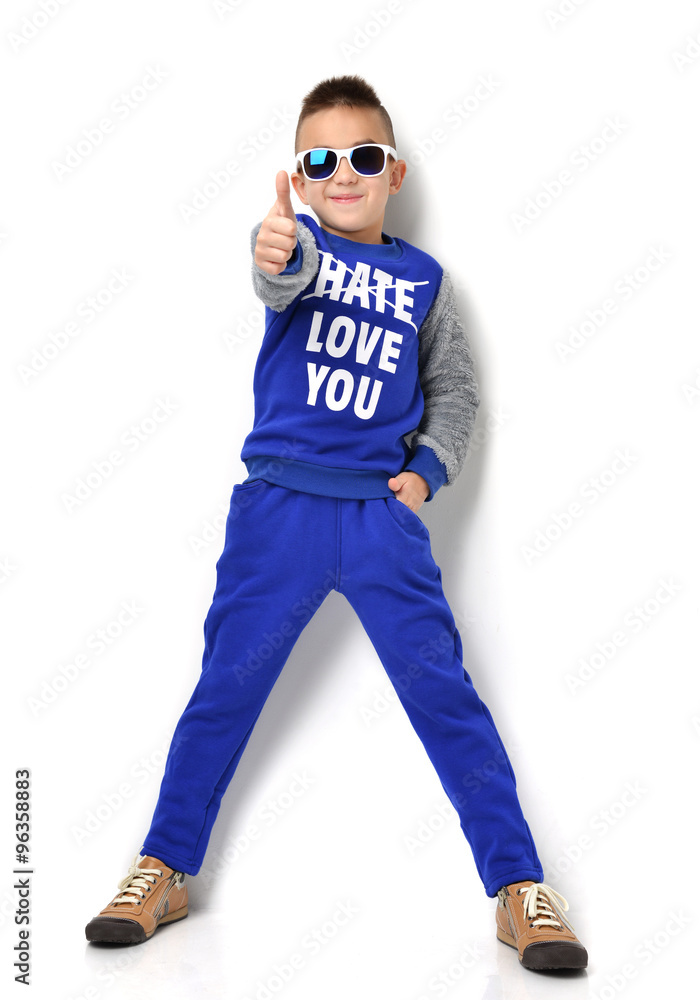 little boy in sunglasses blue cloth jeans standing and giving th little boy in sunglasses blue cloth jeans standing and giving th