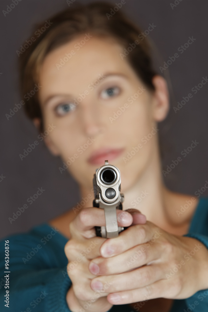 Caucasian woman defending herself using a handgun