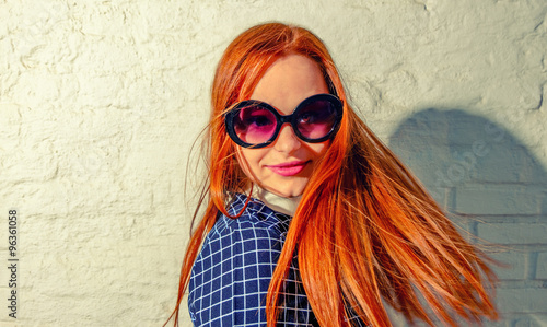 Принти на полотні Trendy carrot-top girl turn around with her hair fly about her