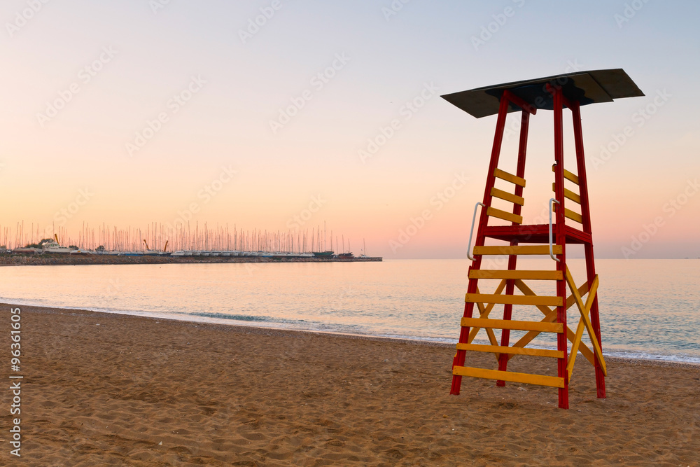 Lifeguard tower on a beach in Palaio Faliro and dry dock of Alimos marina in Athens, Greece.