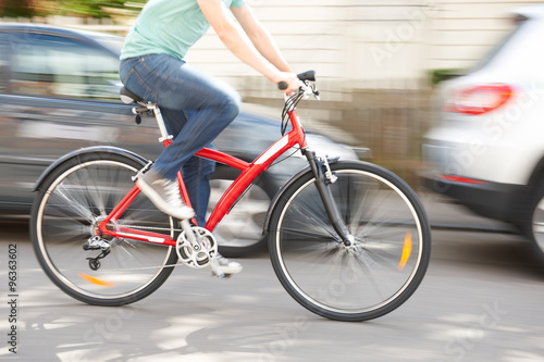 Cyclist At Speed Along Urban Street © highwaystarz
