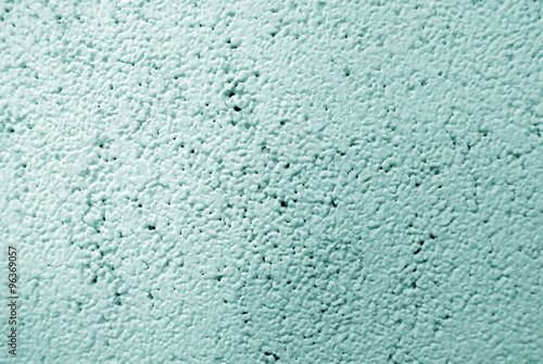 Light green colored wall surface; mortar texture; can be used as background.