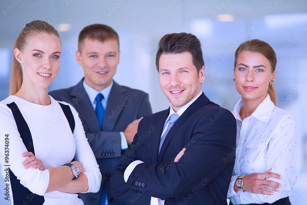 Smiling successful business team standing in office Smiling successful business team standing in office