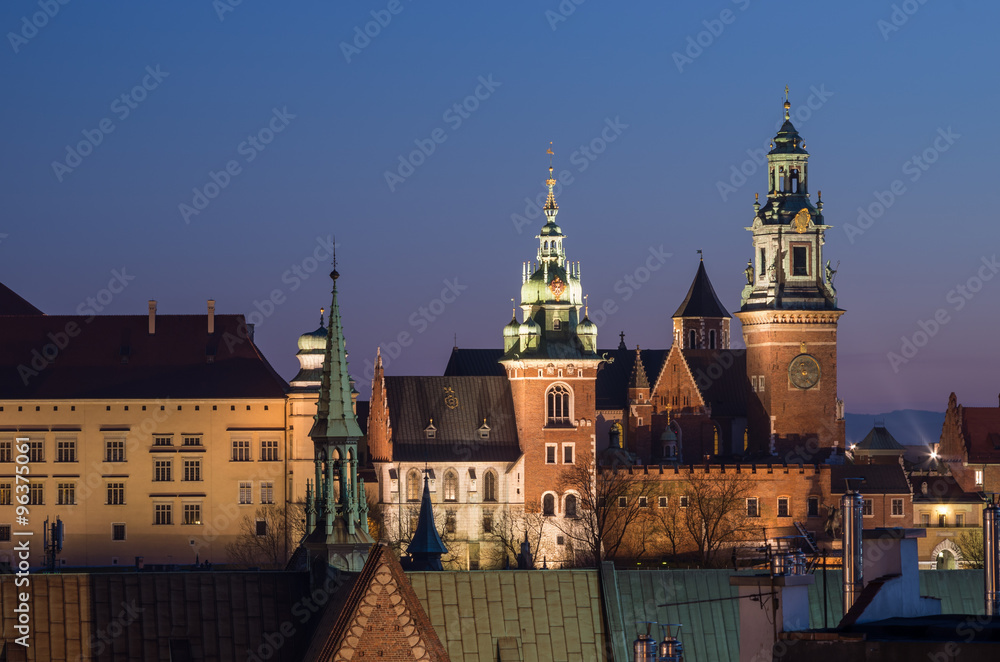 Fototapeta premium Royal castle and cathedral on the Wawel hill seen from the Town Hall tower in Krakow, Poland in the evening