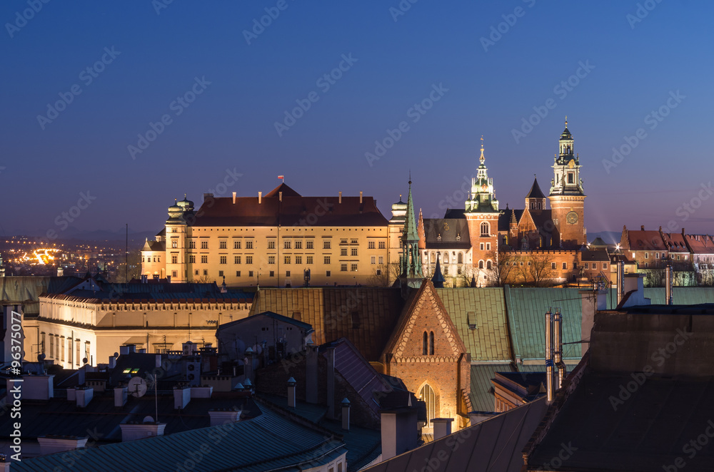 Royal castle and cathedral on the Wawel hill seen from the Town Hall tower in Krakow, Poland in the evening