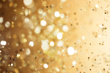 Christmas gold background. Golden holiday glowing abstract glitt
