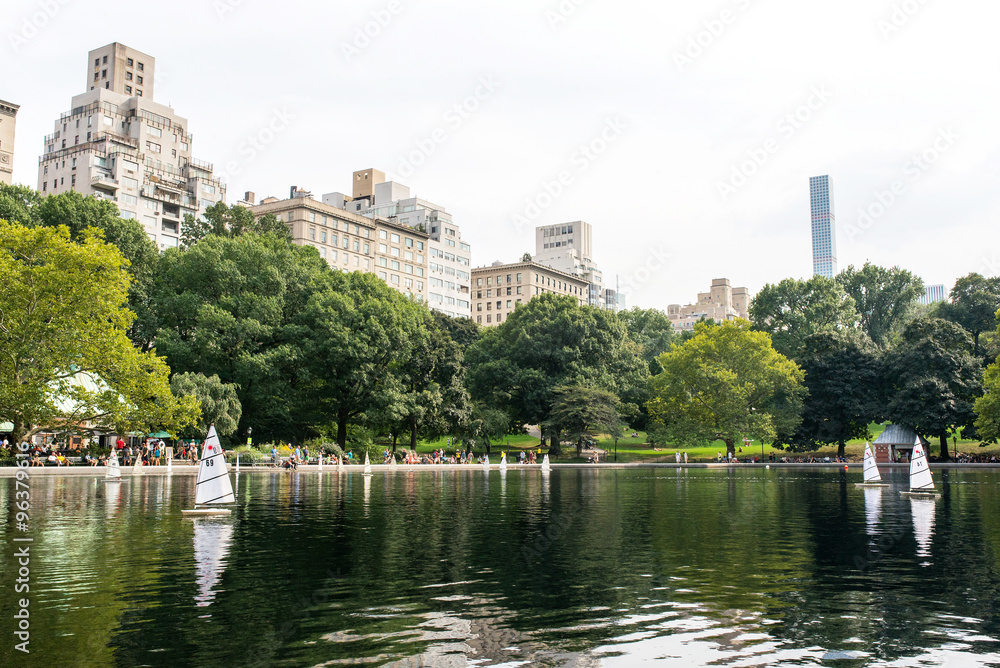 model boats sailing on Conservatory Water in central park in manhattan, new york city