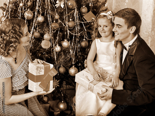 Family with children  dressing Christmas tree. photo