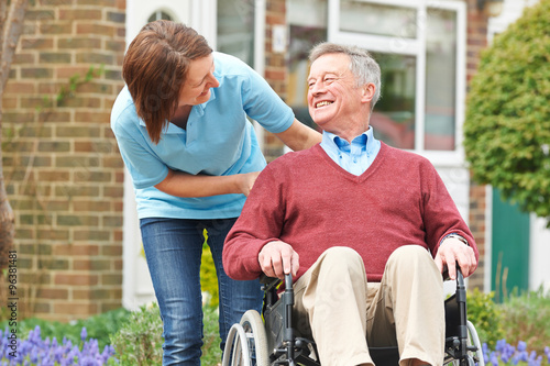 Carer With Senior Man In Wheelchair