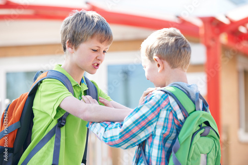 Two Boys Fighting In School Playground photo