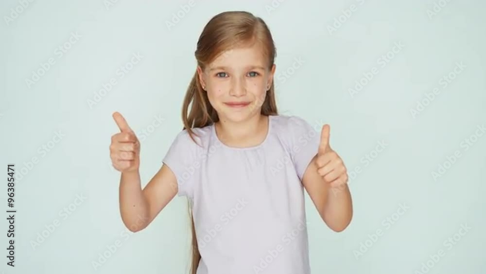 Thumbs up. Ok. Girl is on the white background Thumbs up. Ok. Girl is on the white background