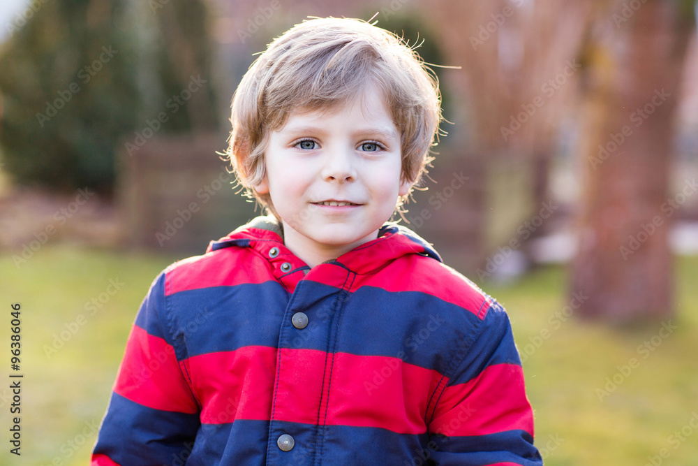 Portrait of happy little kid boy in red jacket, outdoors Portrait of happy little kid boy in red jacket, outdoors
