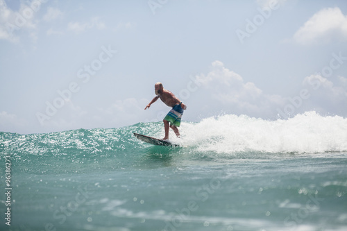 surfer man surfing on waves splash actively