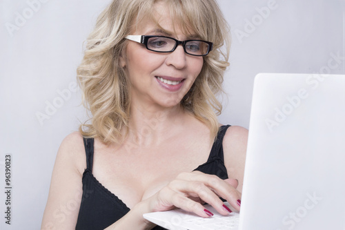 Businesswoman typing on a lap top photo