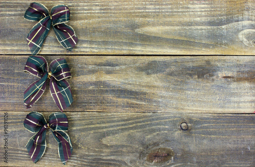 Blank rustic sign with row of holiday bows