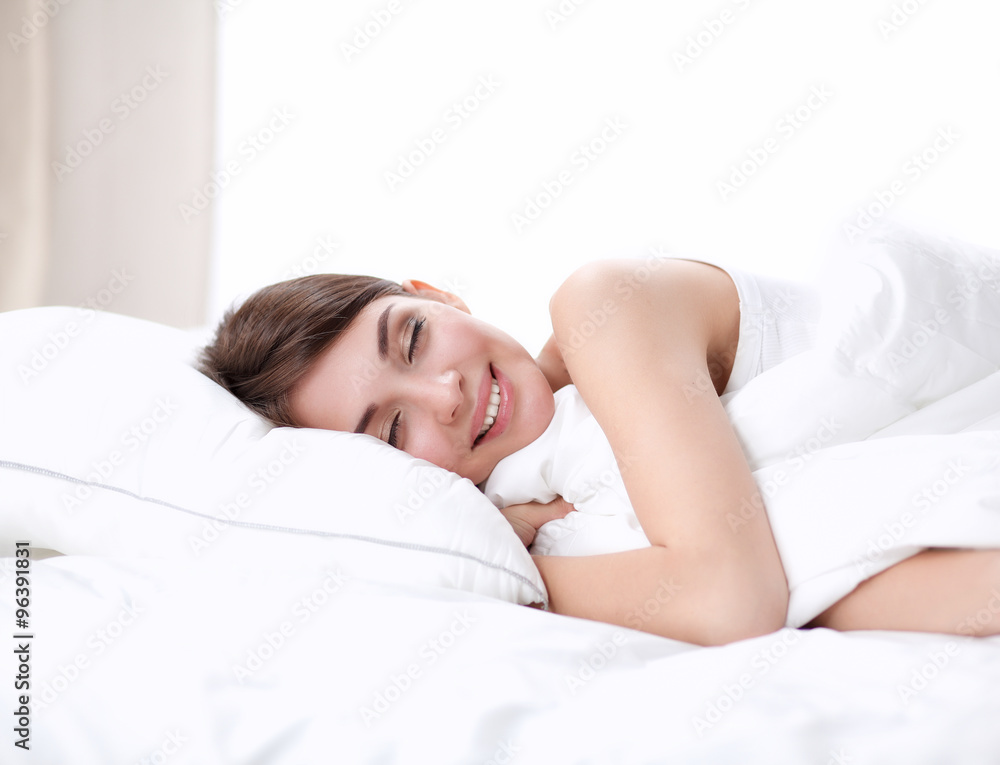Beautiful girl sleeps in the bedroom, lying on bed Beautiful girl sleeps in the bedroom, lying on bed