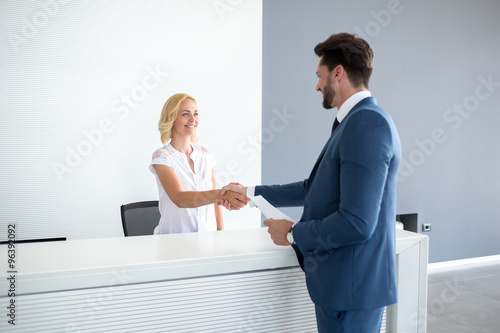 Receptionist wish welcome to guest photo