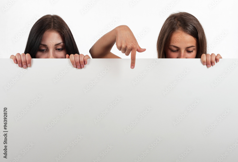Beautiful girl looking down and indicate, on white background Beautiful girl looking down and indicate, on white background