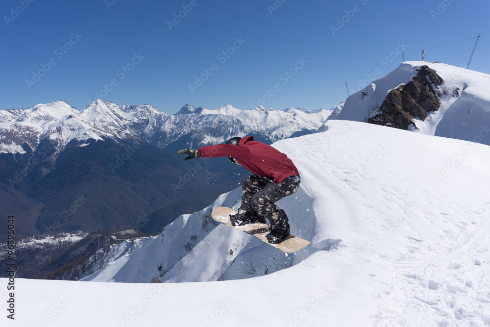 Flying snowboarder on mountains. Extreme sport