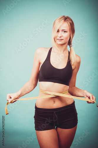 Fitness girl measuring her waistline © anetlanda