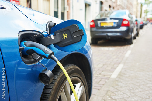 power supply plugged into an electric car during charging
