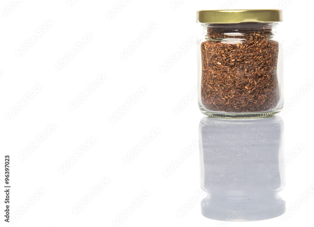 Dried rooibos herbal tea leaves in mason jar over white background Dried rooibos herbal tea leaves in mason jar over white background