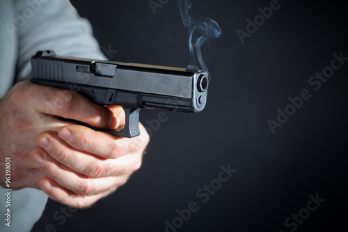 Male hand with a gun