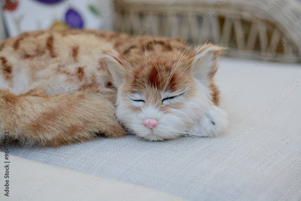 Toy Cat lying on a sofa Toy Cat lying on a sofa
