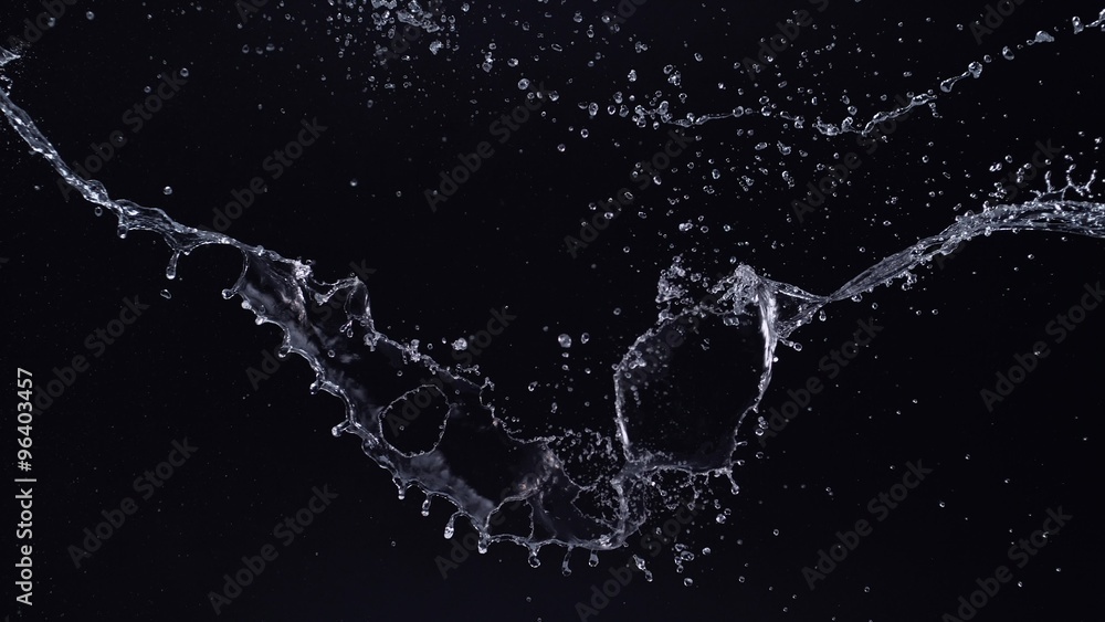 Water splash in midair against black background. Shot with high speed ...