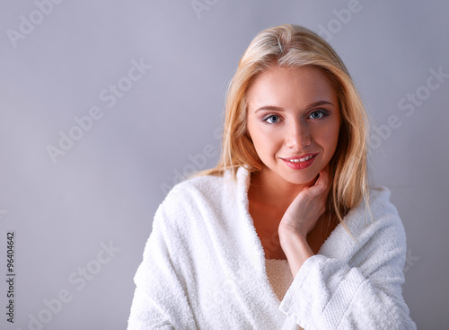 Smiling woman in white bathrobe