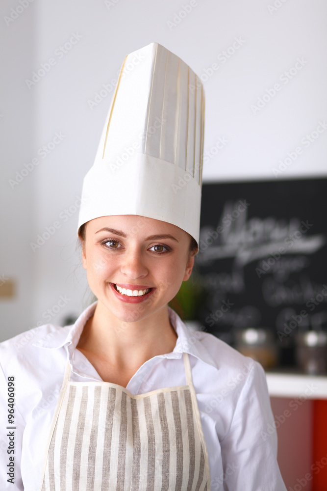 Chef woman portrait with uniform in the kitchen Chef woman portrait with uniform in the kitchen