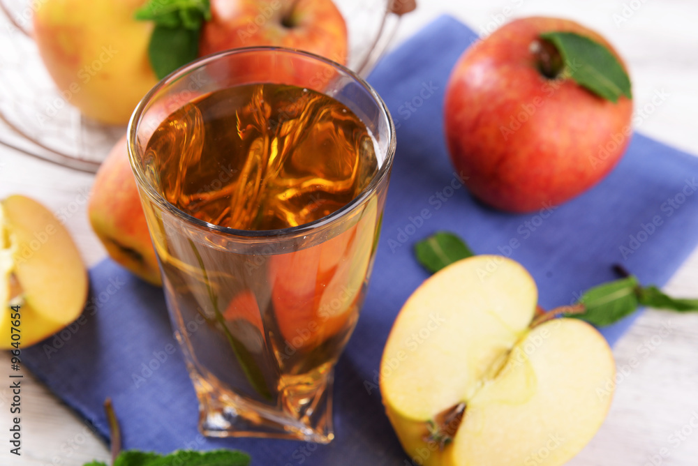 Glass of apple juice with fruits and fresh mint on table close up Glass of apple juice with fruits and fresh mint on table close up