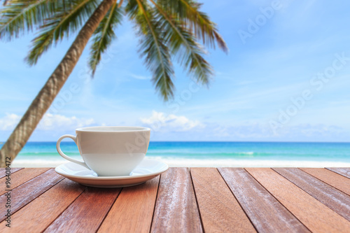 White coffee cup on wood table and view of nature background