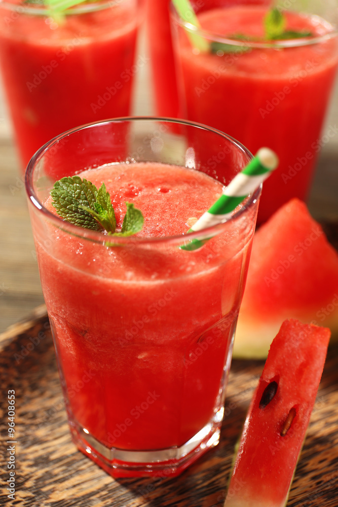 Glasses of watermelon juice on wooden table, closeup Glasses of watermelon juice on wooden table, closeup