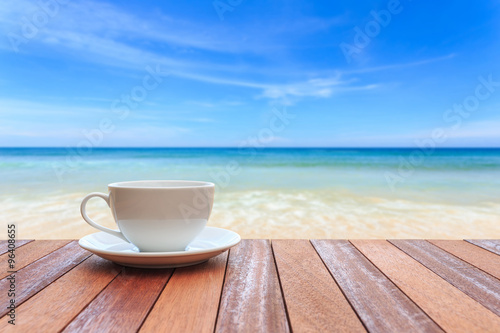 White coffee cup on wood table and view of nature background