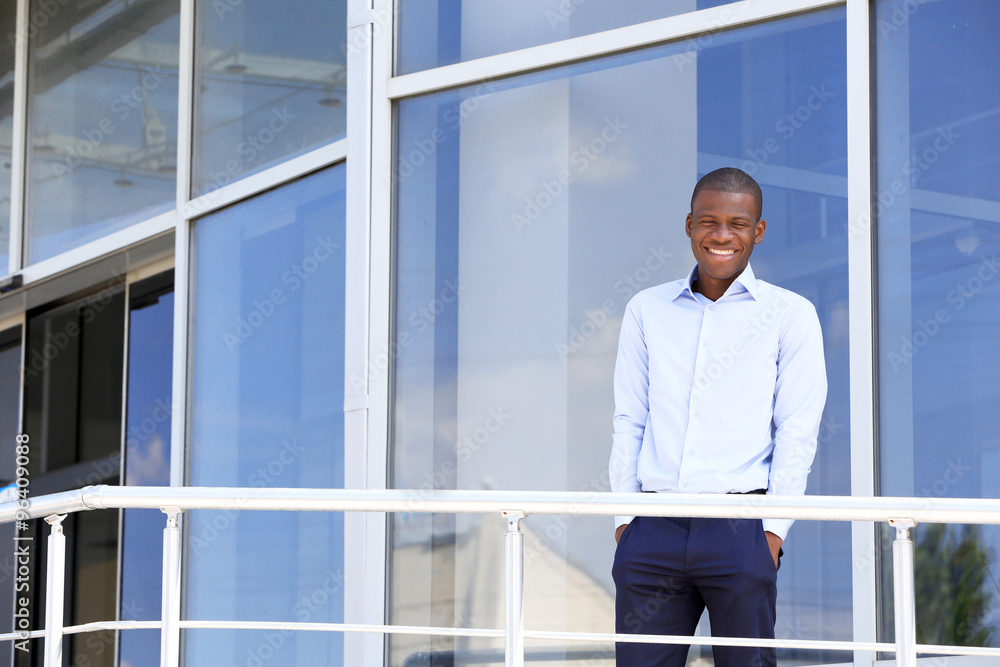 Handsome African American businessman near business centre Handsome African American businessman near business centre