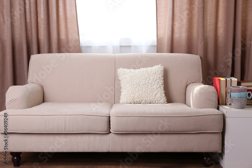Comfortable sofa with pillows in the room, close up © Africa Studio