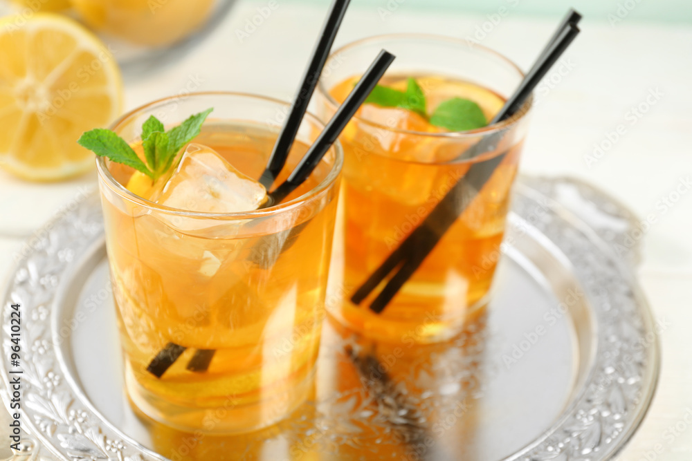 Iced tea with lemon on light wooden background Iced tea with lemon on light wooden background